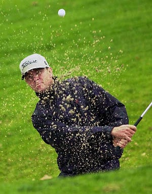 Davis Love III blasts out of the bunker near the ninth green during the third round of the Nissan Open at the Riviera Country Club in Los Angeles Saturday.
