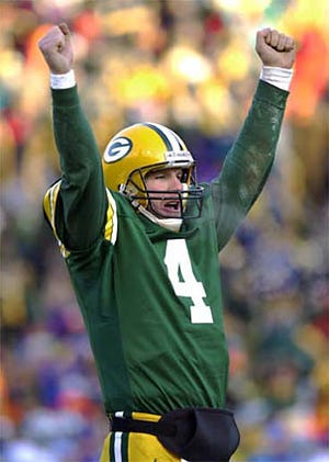 Packers quarterback Brett Favre reacts after throwing a touchdown pass in December against the Detroit Lions. Favre re-upped with Green Bay on Friday for a reported $100 million over 10 years.