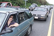 Joode Campbell of Burlington, Vt., waits in the westbound lane of Route 6 between Exits 3 and 4 yesterday to get to the Sagamore Bridge. Campbell, who used to own a business in Provincetown, is familiar with the Sunday traffic backup, but says "I?ll never get resigned to it."