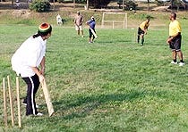 The eighth annual Jamaican Independence Day Festival, held at the Veterans of Foreign Wars Brown James Buck Post in West Chatham yesterday, included a match of cricket between the men and women. Here, June Thompson waits at the wicket as the ball is bowled.