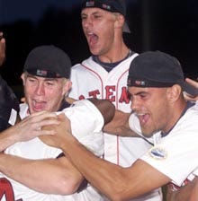 Keith Butler (4) celebrates with Wareham teammates Mark Mager, center, and Mike Huggins, right, after scoring the winning run in the bottom of the ninth as the Gatemen shaded Chatham, 4-3, in the finale.