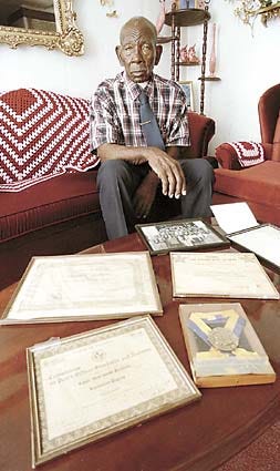 Frazier Neumon sits in his home Tuesday with memorabilia from his 29-year career with the Haines City Police Department.