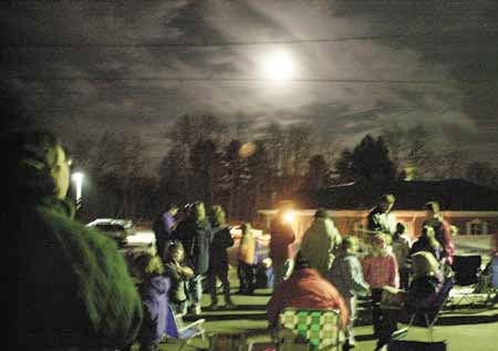Parents and children gathered outside Atkinson Academy during the first annual "Moon Journal Evening" outside Atkinson Academy Monday night. The children were allowed to sketch the moon and write about it in their journals.
