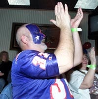 Art Ross of Mashpee was one of 150 packed into Dino's Sports Bar on Route 151 in Mashpee last night. Painted faces, dyed hair and an abundance of red, white and blue added to the exuberance of Super Bowl Sunday for New England fans.
