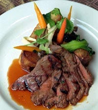 Teriyaki grilled flank steak, one of the dishes served by executive chef Paul Wildermuth at the Red Light restaurant in Chicago, adds Asian flavor to barbecued beef.