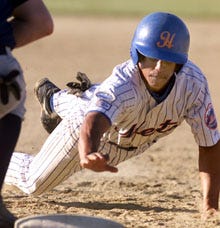 Mike Griffin of the Hyannis Mets dives back to fist base to avoid getting picked off during last night's Cape League game. The Mets went on to a 6-4 wi over Harwich at McKeon Field in Hyannis.