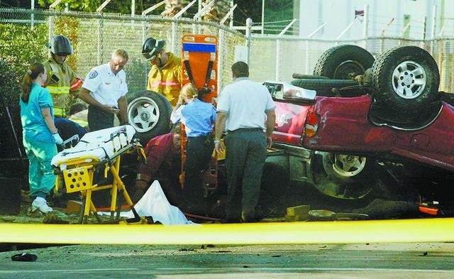 DAVID MILLS/Ledger photos
Investigators look over wreckage from a two-vehicle accident on North Wabash Avenue south of New Tampa Highway in Lakeland early Sunday. Three people died. Below, a man is removed from the scene.