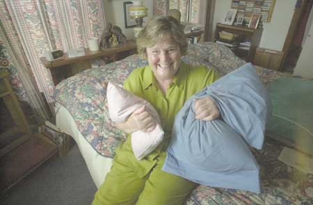 Heidi Fogarty of South Berwick, Maine, hugs two of the buckwheat pillows she created through her business, L-OMA Buckwheat Pillows. She uses only organic buckwheat and sometimes adds lavender for its soothing quality.
