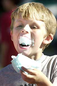 Jacob Graves, 6, of Greenland enjoys a mouthful of cotton candy during a visit to the Stratham Fair on Thursday.