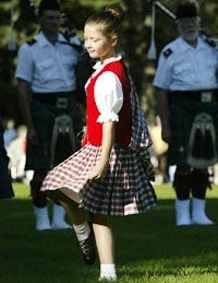 Louisa Hopewell, 9, with the Chatham-based Summers Smith Scottish Dancers, dances yesterday during Scottish Pipe Band Day at Heritage Museums and Gardens in Sandwich.