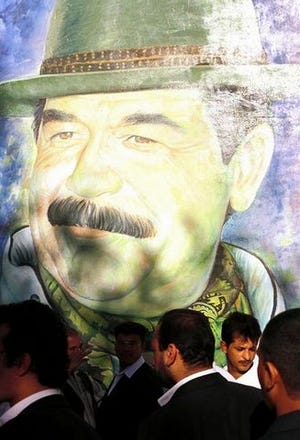 JAMES HILL/The New York Times
Among the major networks, only CNN has a fully staffed bureau in Baghdad. Voters recently elected Saddam Hussein for the next seven years, whose image is seen on a wall in that city.