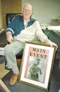 George Reiniger, with a poster from his heyday, when he was better known as "the German Oak."