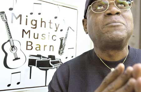 Sam MCClain sings outside his "Mighty Music Barn" at his home in Epping.