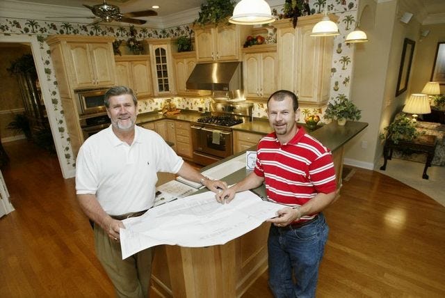 RICK RUNION/The Ledger
Bill Branham, left, and his son, Ken, show the kitchen of their parade model. The Ashley won all the categories in the $300,001 to $350,000 price range.