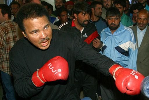 American boxing legend Muhammad Ali shows his skill during a sparring with an Afghan boxer at a boxing club in Kabul, Monday. Ali, who was named "U.N. Messenger of Peace" in 1998, arrived in Kabul Sunday on a three-day mission in the war-ravaged country.