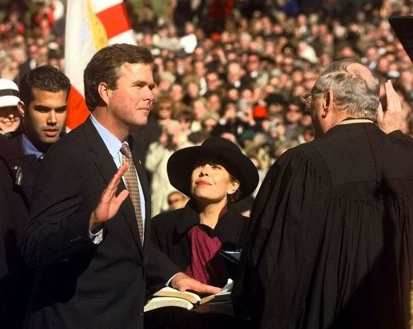Gov. Bush is sworn in for his first term on Jan. 5, 1999, in Tallahassee by Florida Chief Justice Major Harding, right. Bush's wife, Columba, is at center and their son, George P. Bush, at left.