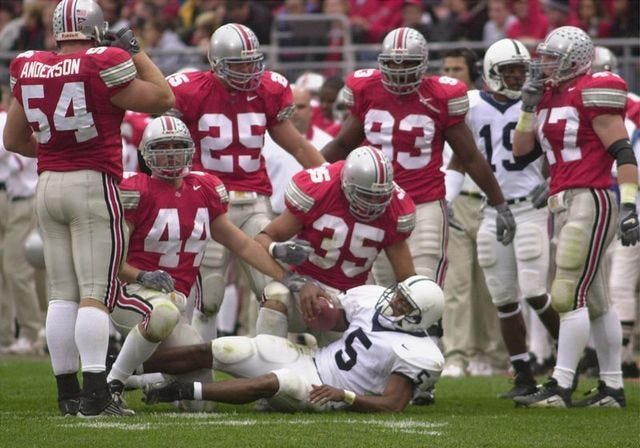 Ohio State defenders stand over Penn State running back Larry Johnson after stopping him earlier this season. The Buckeyes know they have their hands full against Miami in the Fiesta Bowl.