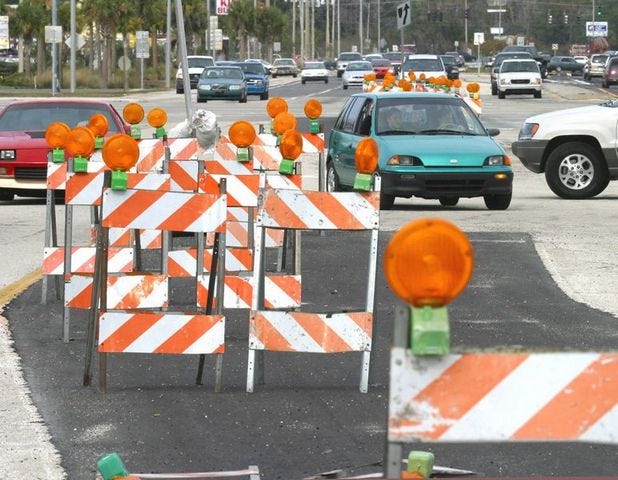 Traffic moves between two rows of barriers on Broadway Avenue just south of State Road 60 on Thursday in Bartow.