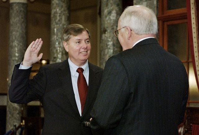 Sen. Lindsey Graham, R-S.C., takes the oath of office with Vice President Dick Cheney, right, during a re-enactment swearing-in ceremony Tuesday in the Old Senate Chamber on Capitol Hill in Washington.