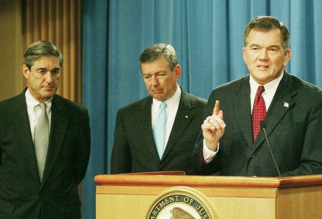 Secretary of Homeland Security Tom Ridge, right, speaks as Attorney General John Ashcroft, center, and FBI Director Robert Mueller, left, look on during a news conference announcing the raise in the terror threat level to "High" at the Justice Department in Washington, on Friday.