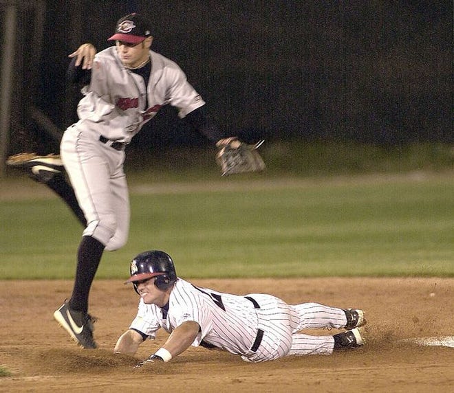 Asheville's Rock Mills slides into second base in an attempt to break up a double play as Capital City's Corey Ragsdale throws to first during Thursday's 2003 season opener at McCormick Field.