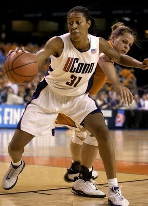 Connecticut center Jessica Moore (31) protects the ball from Texas
forward Stacy Stephens, right, in the first half of their semifinal game at the NCAA Women's Final Four on Sunday in Atlanta.