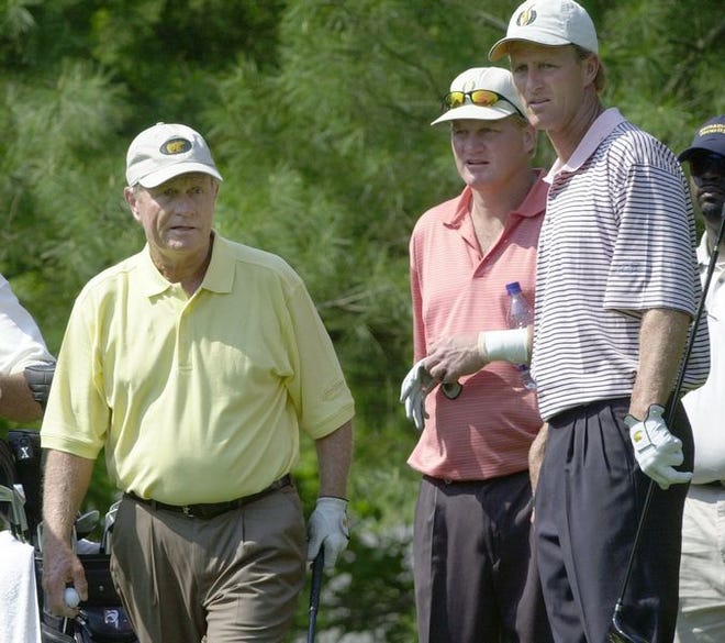 Jack Nicklaus, left, prepares to hit his tee shot as his sons Steve, center, and Jack Jr., look down the 14th fairway on Wednesday during the practice round for the Nationwide Tour's BMW Charity Pro-Am at The Cliffs at Keowee Vineyards in Sunset. The 63-year-old Nicklaus will play in the
tournament with his four sons.