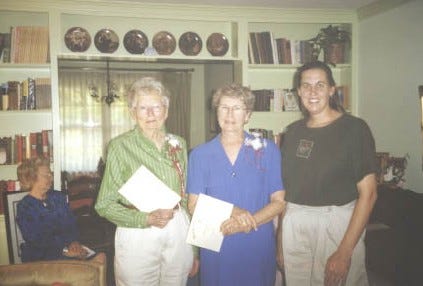 Chapter President Camilla Donnely, right, presented certificates of appreciation to Dot Macnamara, left, and Jesslyn Bates, two charter members of the William Anderson Sanders Chapter of the United Daughters of the Confederacy at the chapter's recent 20th anniversary.