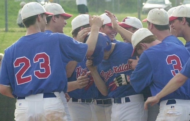 Riverside's Drew Crisp is swamped by teammates after a fourth-inning

solo homer against Berea on Friday afternoon at Riverside.