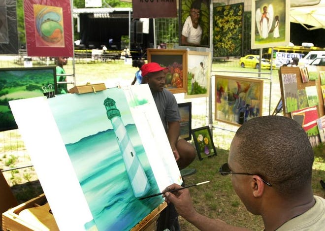 Dr. Anthony Green paints a lighthouse while his friend Rootman looks on at the 5th Avenue Arts Festival on Saturday. Green said that his mother tells him he has been painting since he was two years old. "It is my therapy, my recreation," Green said.