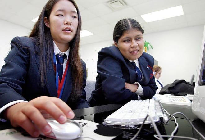 Christina Chung, left, and Veronica Mosso, best friends, work together during a computer class at Grandview Preparatory School.