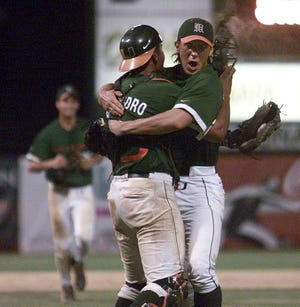 Pitcher Shawn Valdes-Fauli embraces catcher Erick San Pedro, left, after Miami defeated Florida to win its NCAA regional on Sunday.