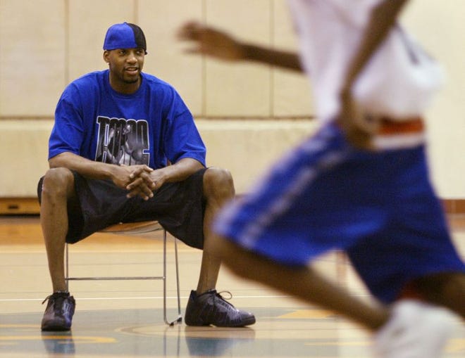 Orlando Magic all-star Tracy McGrady watches the action at his basketball camp being held at Polk Community College.