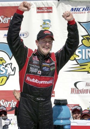 Kurt Busch celebrates in victory lane after winning the NASCAR Sirius Satellite 400 at Michigan International Speedway on Sunday.