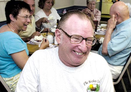 Robert Wells has a laugh during his retirement party at Betty's Kitchen in North Hampton on Friday night. Wells is retiring after 25 years with the North Hampton Department of Public Works.