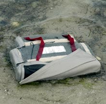A seat cushion from the wrecked aircraft washes ashore on Great Island yesterday afternoon.