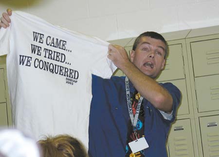 Sanborn regional High School Principal Steven Beals holds up a T-shirt thr school received.