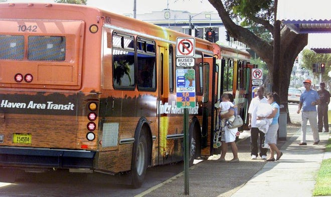 People board a Winter Haven Area Transit bus in downtown Winter Haven. WHAT officials decideto raise some revenue by putting ads on the buses.