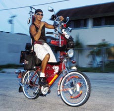 Joachim Ruiz shows off the bike he customized to include not only lights and reflectors, but a stereo, television and alrm amoung other things.
Knight Ridder Tribune Photo