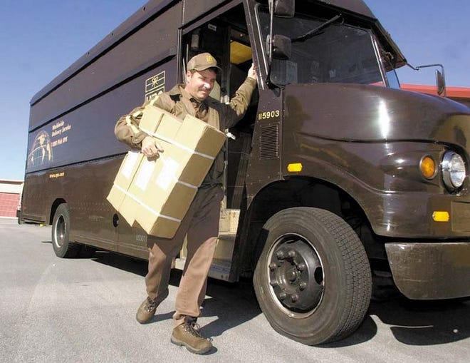 UPS driver Jeff Spangler delivers a package in Roswell, Ga., on Tuesday. Atlanta-based UPS says the majority of its packages this holiday season will come in with key information already entered electronically by customers, including who the shipper is, who the receiver is, the weight of the package and the service level desired such as next-day air or ground delivery.