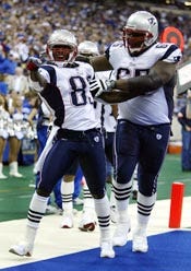 New England Patriots receiver Deion Branch, left, celebrates with linemen Damien Woody after scoring a touchdown in the fourth quarter against the Indianapolis Colts. The go-ahead touchdown gave the Patriots a 38-34 win.