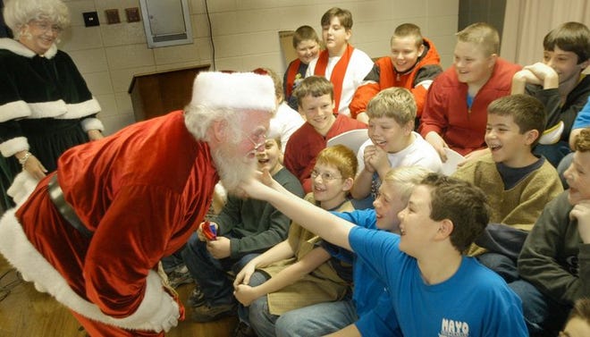 Wayne Owens learned early on that when he's filling in for Santa around the Upstate, his beard must be authentic. He and Nana Claus surprised Mayo Elementary students recently, where the fifth-grade chorus gave Santa's beard a tug, just to make sure.
y the couple went on stage to see the 5th grade chorus who wanted to check out Santas beard. It was real. The couple does not charge for the visits they make to schools and other places spreading the Christmas cheer.