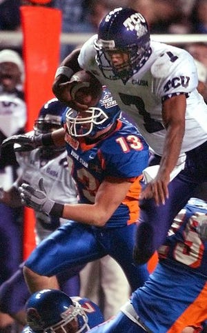 TCU quarterback Brandon

Hassell leaps through a pile of Boise State players.