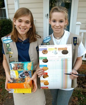Cadets Caroline Gieser and Erin Kelly of Girl Scout Troop 142 are ready for the annual cookie sales, which they hope will fund a trip to Switzerland.