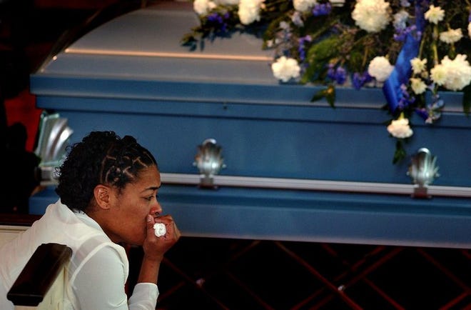 Sandy Miller weeps beside her son's casket during his funeral Friday at the First Baptist Church in Statesville, N.C. Antonio "Mookie" Miller, 13, was one of seven teenagers killed in a car crash Monday while fleeing police.