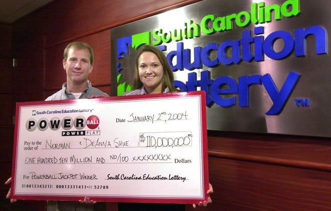 Norman and Deanna Shue of

Concord, N.C., who won $110 million in The South Carolina Education

Lottery, show off their check Friday in Columbia.