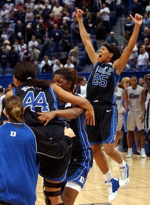 Duke's Brittany Hunter, 44, Iciss Tillis, center and Monique Currie celebrate after the Blue Devils 68-67 upset win over
Connecticut.