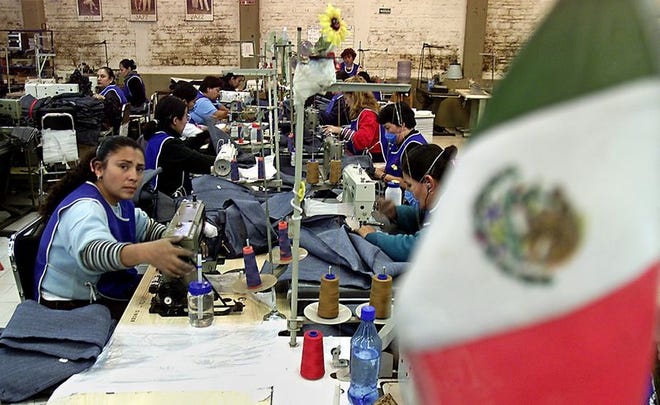 Seamstress Raquel

Martinez, left, produces clothes for

Sam's Club and Wal-Mart at Camen's

Confections in Guadalajara City, Mexico.
Camen makes clothing for Wal-Mart and Sams Club. As the North American Free Trade Agreement turns 10 on Jan. 1, 2004, supporters and detractors are engaged in a heated debate about the future of the precedent-setting commerce treaty as well as its impact on free trade in the Americas and around the globe.(AP Photo/Guillermo Arias)