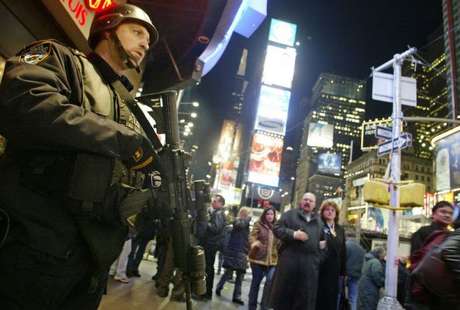 A member of the New York City Police Department Hercules Team patrols New York's Times Square. Since the nation went on an orange terror alert, states and cities have spent millions of dollars on security.
