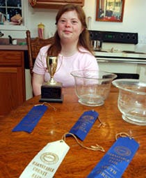 Tracey Newhart at home with some of the awards she has won for her cooking. Tracey received a local diploma yesterday from Falmouth High School.